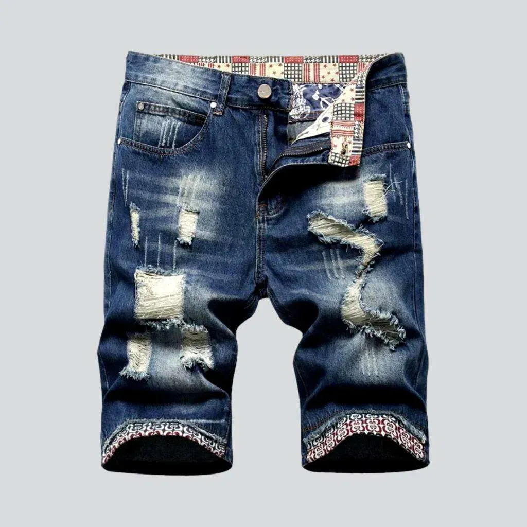 Mid-wash distressed denim shorts